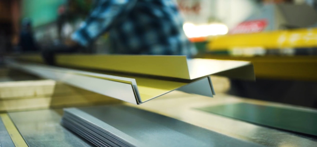 Close-up of cold-formed Z-purlin and C-girt steel profiles on the Makloc roll former line