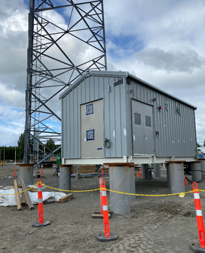Makloc skid mounted telecom equipment shelter on piles at a tower base